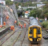 What at first glance might seem like an extreme way of avoiding the ticket barriers... is in fact part of the extensive safety work carried out during September and October 2009 on rock faces at the western end of the Kyle line. This resulted in temporary closures to both road and rail links during the period. This scene shows work in progress just outside Kyle of Lochalsh station on 29 September as the 1435 service leaves for Inverness. Note the old Kyle signal box still standing in the background.      <br>
<br><br>[John Furnevel 29/09/2009]