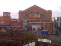 The famous neon sign on the Brush Falcon works at Loughborough. Bit of a cluttered foreground. The sign was illuminated on my return, but I ran for the train - it was a 40 minute wait for the next one. Notice that Loughborough is now one of three stations advertising connections to East Midlands Airport. [see image 26414] Notice also, the handy tower-ette (not Tourette!) for train spotters on the left.<br><br>[Ken Strachan 13/11/2009]