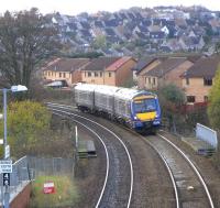 As can be seen from this picture Dunfermline is a hilly town, and <br>
there's a sharp climb from Dunfermline Town station to Townhill <br>
Junction, a few hundred yards behind the camera. The old Class 117 DMUs, finally replaced 10 years ago this month, seemed to make particularly heavy weather of this grade, and there was a sigh of relief in the carriage when Townhill Junction was reached and everything stopped vibrating. Making less of a fuss here on Sunday 15 November is 170 416 with an Outer Circle working about to Call at Queen Margaret. <br>
<br><br>[David Panton 15/11/2009]