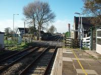 Hoscar is sited on a long straight running from Parbold to beyond Bescar Lane, although it undulates noticeably. This is the view from the Wigan bound platform looking towards Burscough and Southport showing the staggered platform arrangement and the line rising gently to cross the Leeds Liverpool Canal before dipping under the Preston  Ormskirk line.<br><br>[Mark Bartlett 09/11/2009]