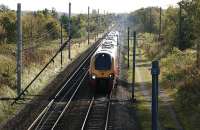 Looking south 'up' the WCML towards the site of Standish station (in the distance), just north of Wigan, as a Virgin Voyager from Birmingham New Street to Edinburgh tries to make up lost time on 16 October 2009.<br><br>[John McIntyre 16/10/2009]