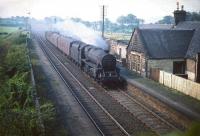 Opened by the Glasgow, Paisley, Kilmarnock and Ayr Railway in 1840 as Lochwinnoch, the station was renamed Lochside in 1905 after a second Lochwinnoch station, nearer the town, was opened by the G&SW on the Kilbarchan Loop. This photograph shows Lochside in 1959, some 4 years after closure, with Black 5 4-6-0 no 44721 heading north with a parcels train. The station was subsequently reopened to passengers in June 1966, co-incident with the closure of the Kilbarchan Loop and the 1905 station. Lochside reverted to its original name of Lochwinnoch in May 1985.<br><br>[A Snapper (Courtesy Bruce McCartney) 21/08/1959]