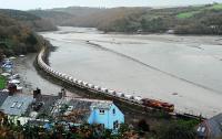 China Clay from Goonbarrow, Rock Dries Siding, passes Golant as it approaches the unloading facility at Carne Point just north of Fowey. Moments before the train arrived a number of 'pedestrians' had to quit the trackbed. Readers of RAIL 630 will find this viewpoint strangely familar (p70) although a few houses have been repainted (and built) in the intervening years.<br><br>[Ewan Crawford 18/11/2009]