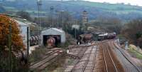 On the right the Wednesdays only St Blazey - Penzance (Long Rocks) - St Blazey oil train scoots east back through Burngullow. On this occasion this was one tank. To the left is a <i>Steelman</i> locomotive in the Blackpool Driers sidings. The mainline (the two tracks to the right) between here and Probus (9 miles west) has been re-doubled in recent years. [See image 11880.]<br><br>[Ewan Crawford 18/11/2009]