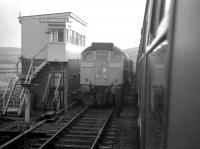In early 1967 a northbound Edinburgh-Inverness service overtakes an engineers train at Dalanraoch loop, mid-way along the recently-singled section between Blair Atholl and Dalnaspidal. Even in the mid-1970s Inverness-based goods guards were in the habit of describing this location as 'Dalnacardoch', after the nearby former signal box on the previously double-track route - which was of course re-doubled in the 1970s to accommodate a resurgence of North Sea oil and Invergordon aluminium smelter freight traffic. <br><br>[David Spaven //1967]