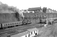 The approach to Bradford Exchange in the 1960s showing an LMS 2-6-4T heading up the bank, a Class 24 approaching with what is probably empty coaching stock, and a Class 40, possibly waiting to become the train engine for that stock. At this time Bradford Exchange enjoyed through trains to London and these continued even after the station was cut back prior to becoming the much simplified Bradford Interchange  [see image 25061] The platforms for the 'new' Interchange station now extend almost to the point where the original signal gantry stood.<br><br>[Robin Barbour Collection (Courtesy Bruce McCartney) //]