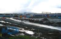 With Bathgate shed now <I>disposed of</I> [see image 25412], the whole of the northern area of the former yard has become one large building site with work progressing on access roads, car parking and other infrastructure associated with the new Bathgate station. Part of the site is seen here on an overcast 27 November looking south east from the main road as the 1124  service for Waverley, having just commenced its journey, passes through what looks like (thanks to the recent rain) a mini series of lochs and canals.<br>
<br><br>[John Furnevel 27/11/2009]