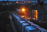 Shunting in the half light. I must say if I were involved I'd like to be dressed in bright orange too. This train is the empties on arrival from Fowey being handled at Parkandillack - a complex operation involving, for some of the time, the locomotive both pushing and pulling rakes of wagons simultaneously. The view looks north and this freight line once continued north to join the Newquay line at St Dennis Junction. Today it is a branch from Burngullow (you can just see the buffer in this shot). There were plans to re-open the line  northwards to St Dennis Junction and upgrade the line for passengers. The line from St Dennis Junction to Goonbarrow Junction would be abandoned and from there to Par given over to freight. Fortunately for the small villages at Roche, Bugle and Luxulyan this has not gone ahead.<br><br>[Ewan Crawford 18/11/2009]