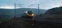 Another of my attempts to get completely soaked in under 30 seconds (successful, again). A southbound Pendolino approaches Crawford Viaduct from the north in bucketing rain. Due to the very heavy rain the nearby single track road was flooded.<br><br>[Ewan Crawford 23/11/2009]