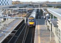 A Glasgow - Edinburgh shuttle running east under the recently erected wires through Edinburgh Park station on 27 November 2009. The train has just passed below the partially constructed bridge that will eventually carry Edinburgh's trams over the E&G main line on their way to Edinburgh Airport.<br>
<br><br>[John Furnevel 27/11/2009]