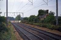 The Colchester to Clacton and Walton line has lost only two stations during its history, but oddly both closures have been to the detriment of the largest community en route. Thorrington (sited between Alresford and Great Bentley and the nearest of the three stations to the port of Brightlingsea) was the first closure in November 1957. Remnants of the platforms and a waiting room were still present in 1976 as recorded here. The second station closure was Brightlingsea (served by a branch from Wivenhoe) in 1964. It had been temporarily closed in 1953 when floods washed away sections of the track. A local campaign to reopen Thorrington was rejected in 2002. Quite why the inhabitants of Brightlingsea and its vicinity have deserved such bad luck with their rail services remains a mystery!  With thanks to the crossing keeper for allowing me to get a photo between trains. <br><br>[Mark Dufton 30/08/1976]