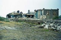 Looking as if it has received a direct hit from a missile, the terminus at Ilfracombe undergoing demolition on 8th September 1976. We might imagine a prophet of doom here on a summer Saturday in 1956, trying to convince station staff struggling with thousands of arriving and departing holidaymakers that, 20 years in the future, three men and a bulldozer would be busy wiping the premises off the map forever. The equivalent challenge in 2009 is to try this at a motorway services area on the M6...<br><br>[Mark Dufton 08/09/1976]