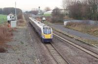 Northern Rail <I>Adelante</I> unit 180103 passes Salwick (No.2) signal box, immediately east of Salwick station, on a Blackpool North to Manchester Victoria service. Approaching from the east is 158752 running from York to Blackpool. Salwick is a 'fringe box' for Preston signalling centre and retains an emergency crossover and a disused siding alongside the Springfields nuclear fuel plant, part of which can be seen above the train. <br><br>[Mark Bartlett 01/12/2009]