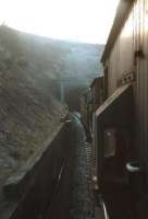 The seldom photographed north portal of Whitrope Tunnel, seen in December 1968 about to swallow up an EE Type 4 hauling a freight, which includes an EURS brake van trip. The train had been photographed earlier in the day at Heriot station [see image 26200]. <br>
<br><br>[Bruce McCartney /12/1968]