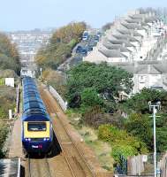 A 125 passes Dockyard (Devonport) in the foreground and approaches Keyham station crossing a viaduct of the same name. There's something reminscent of Durham in the pattern of those roofs to the right. In a very short distance the line crosses numerous viaducts going west from Plymouth.<br><br>[Ewan Crawford 20/11/2009]