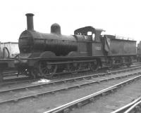 Possibly the oldest operational locomotive on BR at the time, Johnson ex-Midland Railway 2F no 58128 off Bescot shed (3A) stands in the yard at Toton in October 1962. The 0-6-0 had most likely worked in on a freight from Bescot yard earlier that day.  No less than 935 of these locomotives were produced, with this being one of the earliest examples, built by Kitson in 1875. After an operational life of 87 years, 58128 was cut up at Derby Works a few months after this photograph was taken. <br>
<br><br>[David Pesterfield 21/10/1962]