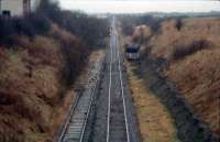 Kilmarnock looking to Dalry. The buffer of the line to the left remained in place until recently. These lines were lifted and converted into a footpath. The near portion is now in the process of being relaid as a rounding loop for coal trains.<br><br>[Ewan Crawford /01/1988]