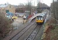 The old goods shed in Cherry Tree yard is still in use, currently as a showroom for stoves and fireplaces. Lying as it does, at an angle to the main line, it must have been a tight little yard for shunting when open to rail traffic. Northern Pacer 142044 leaves for Preston and Blackpool South.   <br><br>[Mark Bartlett 04/12/2009]