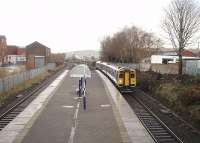 Mill Hill station was a Lancashire and Yorkshire era addition to the East Lancashire line and so was constructed with a L&YR standard island platform, platform canopy and street level booking office. [See image 21199] for a surviving example at Atherton. All original facilities have now been swept away but beyond the platform the goods shed still stands and is in industrial use. 158753 runs through the station with a York to Blackpool service on 4 December in this view towards Blackburn. <br><br>[Mark Bartlett 04/12/2009]