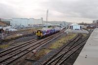 Blackburn, as seen looking west from the adjacent supermarket car park, showing 158842 pulling into Platform 3 on a York to Blackpool service. The one remaining through goods line is to the left of the train and on the far right the four chimneys of the original station building can be seen, still partly in railway use but mainly now the town centre police station. <br><br>[Mark Bartlett 04/12/2009]