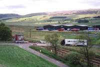 A truck laden with Highland Spring water (from the plant in the background) prepares to cross the main line at Blackford signal box in 2003. If Highland Spring's current proposals come to fruition, then in a few years' time there will be a new private siding connection east of the signal box, with daily container trains carrying the product south to an English Midlands railhead.<br><br>[David Reid (Courtesy David Spaven) //2003]