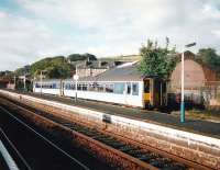 On 20 September 1997, unit 156 456 waits in the bay at Barrhead to return to Glasgow.The platform lighting seems to be giving platform 2 the cold shoulder! Flourescent lighting was already a bit old-fashioned by this time and to be found at only a few locations in Scotland. Barrhead was to be upgraded in a matter of months. <br>
<br><br>[David Panton 20/09/1997]