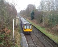 The next stop at Mill Hill is in sight (just by the distant bridge) as 142048 leaves Cherry Tree heading for Blackburn and Colne on a gloomy day. The long platform on the far side is disused apart from a short (2-coach) section.     <br><br>[Mark Bartlett 04/12/2009]