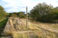 Part of the remains of the 900 ft long platform 4 at Filey Holiday Camp station in October 2009, with several of the platform posts still standing, some with lighting and PA system components still attached. Filey was the biggest of the Butlin's camps at 400 acres, with accommodation for 11,000 campers. Trains ran from all parts of the country with an example of Saturday morning departures in the summer of 1965 over a 2 hour period showing trains for Sheffield Victoria, Scarborough, Newcastle Central, Leeds City (2), Manchester Victoria, Kings Norton and London Kings Cross (2). With the increasing use of the private motor car, rail traffic declined to a point where the station was eventually closed, with the last campers leaving on 17 July 1977. The camp itself closed 6 years later, at the end of the 1983 season. [See image 32210]<br>
<br><br>[John Furnevel 11/10/2009]