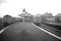 Suitable weather for a unique occasion in British Railways closure history at the ex-GNSR Elgin East station on 4th May 1968 - with the last trains for two different lines waiting side by side prior to departure. On the left at Platform 1 (the through road from ex-HR Elgin West station) is D5331 on the 19.09 (last Up) train to Aberdeen via Buckie, while at bay Platform 2 is a DMU forming the 19.07 (last Up) train via Craigellachie. (The EE Type 4 lurking in the background at the buffer end of Platform 4 is probably off the Scottish Malt Distillers Doncaster - Burghead/Muir of Ord block grain train.) [See image 26815]<br><br>[David Spaven 04/05/1968]