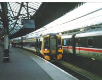 Platform 5 at Aberdeen on 12 October 1998 and the driver of 148 703 is in his cab to take the train south, though the LCD destination blind is yet to be changed from Aberdeen. Although well into privatisation both this set and the sleeper stock next to it are still in BR era livery. The InterCity brand, though defunct here, was picked up by other countries, including, untranslated, Germany.<br>
<br><br>[David Panton 12/10/1998]