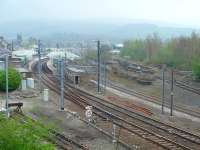 Skipton station, viewed from the overbridge at the north west end, showing the areas still used for passenger trains along with the closed Ilkley and Grassington platforms to the right. The single line still used by trains from Swinden limeworks near Grassington can be seen climbing through the old platforms to the bridge over the Leeds line [See image 13215] and in the station itself a Class 333 EMU is in the bay platform in the left background awaiting departure to Leeds or Bradford. <br><br>[Mark Bartlett 16/04/2009]