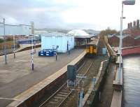 Clitheroe bound trains usually use the loop (Platform 1) at Blackburn while trains for York or Colne use platform 2. 150205 pulls away from Blackburn heading for the Ribble Valley and Clitheroe in this view looking west from the multistorey supermarket that occupies the old fish and parcels depot site. There is a marked contrast between the surviving station entrance building on the right and the rebuilt platform structures.<br><br>[Mark Bartlett 04/12/2009]