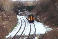 A Leeds to Morecambe service, formed by 150211, pulls away from  Wennington station on New Year's Eve 2009 and passes the site of the junction with the direct line to Lancaster through Halton (closed in 1966). Very little snow remains in the area but this cutting obviously doesn't see much sun at this time of year. [See image 37943] for the same location in 1976.<br><br>[Mark Bartlett 31/12/2009]