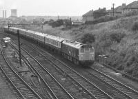 The Edinburgh-Glasgow push-pull sets were normally sandwiched between two class 27 BRCW Type 2s. On this occasion however class 25s are the traction on an Edinburgh bound service heading passed Cowlairs East Junction. The locomotives are 7581 leading and 7590 on the rear. The photograph was taken from the former Caledonian Railway viaduct that spanned the E&G line at the north end of Eastfield shed [see image 9082].<br><br>[John McIntyre 16/09/1972]