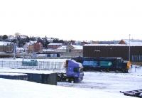 The ends of the east facing platforms at Inverness viewed over the Needlefield Container Depot on New Year's Day 2010. In the foreground, inside the depot, is DRS 37423 <I>Spirit of the Lakes</I> resting between snowplough duties, while an East Coast liveried 125 unit stands in the background.<br><br>[John Gray 01/01/2010]