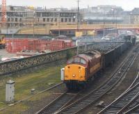 View north as EWS 37716 pulls away from Bradford Interchange in April 1998 with the Laisterdyke - Liverpool Docks scrap metal working, having just run round its train. Note the ongoing development work in the background, including (just off picture to the right) land formerly occupied by Bradford Exchange station. For a 1960s view in the opposite direction, featuring the wall on the left [see image 26905].<br><br>[David Pesterfield 01/04/1998]