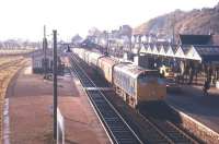 The morning train for Kyle of Lochalsh shortly after arrival at Dingwall in August 1972 - note the Royal Mail van waiting on the platform and the collection of milk churns standing beyond. Notice also that the loop platform line has been lifted by this time. [See image 26966]<br><br>[Colin Miller /08/1972]