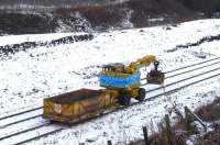 Not quite a Class 66 with a full load of coal hoppers, but the best available on the day! Road-rail backhoe and wagon (or is it a trailer?) heading back from the buffer-stops to load more ballast on 4 January. The buffers visible in the background are at the end of the long disused Johnnie Walker sidings headshunt, and are on the north side of the Barrhead line. Kilmarnock No 1 signalbox used to sit on top of the bank between the Barrhead and Dalry lines more or less above the backhoe's cab. <br><br>[Robert Blane 04/01/2010]