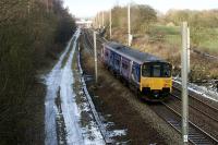 A Liverpool to Blackpool North service in the hands of 150137 heads north between Coppull and Euxton Balshaw Lane on 3 January 2010. At the next bridge over the line is the signal controlling Balshaw Lane Junction and it is indicating the train will take the diverging route onto the slow lines so that it can call at Euxton Balshaw Lane station. To the left of the train is the route of the former slow lines which used to continue south towards Standish.<br><br>[John McIntyre 03/01/2010]