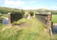 View across the Clyde at Crawford over the bridge that carried the Camps Railway. The 3 ft gauge line was built in the 1920s on behalf of Lanarkshire County Council in connection with the construction of Camps reservoir to the east. The line was lifted in the 1930s and the bridge is nowadays used by hill walkers and as a shortcut by villagers. The former yard and exchange sidings stood just behind the camera alongside the WCML.<br><br>[John Furnevel 05/08/2009]