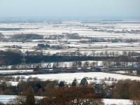 A Class 67 hauled freight drifts south through the site of Scorton station, as seen from local hill <I>Nicky Nook</I>.  Behind the train the Fylde plain stretches out towards Pilling, with Morecambe Bay beyond.<br><br>[Mark Bartlett 09/01/2010]