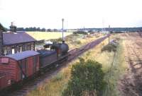 An eastbound freight on the Wansbeck Valley line between Reedsmouth and Morpeth in the 1960s. The train is headed by North Blyth J27 0-6-0 no 65834 and is seen here passing through the closed (September 1952) station of Meldon, Northumberland. <br><br>[Robin Barbour Collection (Courtesy Bruce McCartney) //]