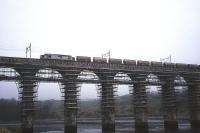 Alumina empties from Fort William to Blyth edge across the Royal Border Bridge behind a Transrail-liveried Class 37 in 1996. At the time, the photographer was undertaking a study of rail freight potential for Berwick-upon-Tweed Borough Council, and phoned the signalman at Tweedmouth signal box to ask when the train was expected. The reply came: <I>Well he's in the station loop at Berwick waiting to be overtaken by a southbound passenger, but I'll bring him across the bridge to Tweedmouth loop so you can get your picture!</I><br>
<br><br>[David Spaven //1996]