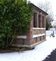 Aberdour didn't get a station until 1890 when the Forth Bridge and its connecting line to Burntisland opened. The full set of original <br>
buildings remains, including the low-rise signal box seen here on 10 January.  That laurel, though a fine constituent of Aberdour station's famous garden, would not have been allowed to grow quite as high when the box was in use.<br><br>[David Panton 10/01/2010]