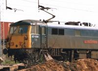 87034 <I>William Shakespeare</I> passing Hillmorton goods yard, south of Rugby, at speed with a down express passenger service on 12 April 1988. A southbound intermodal freight service can also be seen on the adjacent Northampton lines.<br><br>[David Pesterfield 12/04/1988]