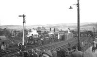 77003+76049 standing at Kirkby Stephen East station with a special on 20 January 1962. The 9-coach RCTS railtour is <I>The Stainmore Limited</I>, organised to mark the end of railway operations over the 1,370 ft Stainmore route.<br>
<br><br>[K A Gray 20/01/1962]