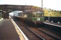 Westbound DMU service, destination Corstorphine, shortly after arrival at Drem in 1958. In the right background the local version of <I>The Railway Children</I> looks on from the fence alongside the overbridge.<br><br>[A Snapper (Courtesy Bruce McCartney) //1958]