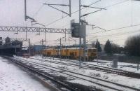 Tamper, tamper: a <I>Colas Rail</I> dual tamper unit waits to set off for a bit of 'one part ballast, one part snow'. Part of the crew had walked down from the recently-built office complex near the formner Abbey Street station.<br><br>[Ken Strachan 11/01/2010]