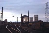 Evening at Thornton in June 1967, looking west, a few months after the end of steam. On the left is part of Thornton Junction shed, closed the previous April. In the centre is Thornton Weighs box, one of 9 signal boxes located in the Thornton area. On the right stand the winding towers of the ill-fated Rothes Colliery. Trumpeted as one of the new <I>super pits</I> on its opening in 1958, the decision was taken to abandon it four years later due to insurmountable flooding and geological problems. Remarkably the towers stood for a further 30 years until eventually demolished using explosives in 1993.<br><br>[Frank Spaven Collection (Courtesy David Spaven) /06/1967]