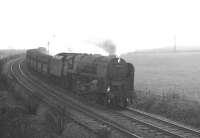 BR Standard class 9F 2-10-0 no 92098 running downhill near Annfield Plain with iron ore empties from Consett on 15 February 1964.<br><br>[K A Gray 15/02/1964]